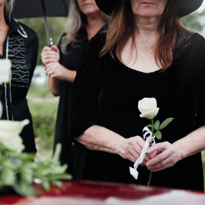 Women mourning at parents' funeral