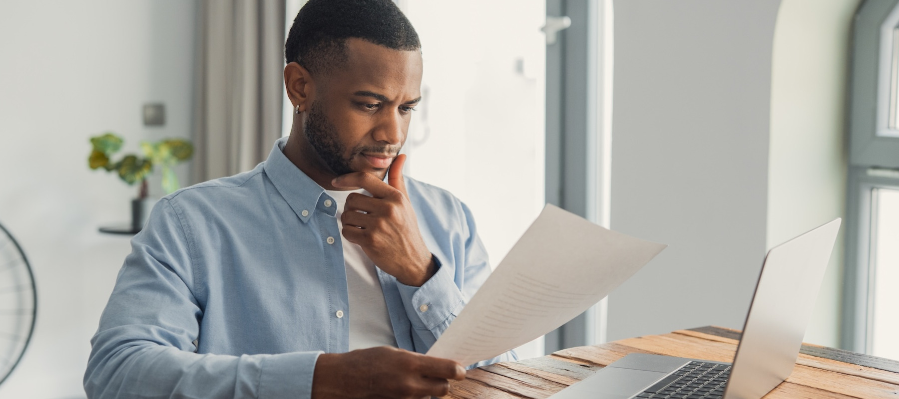 Man looking at financial documents.
