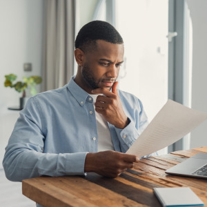 Man looking at financial documents.