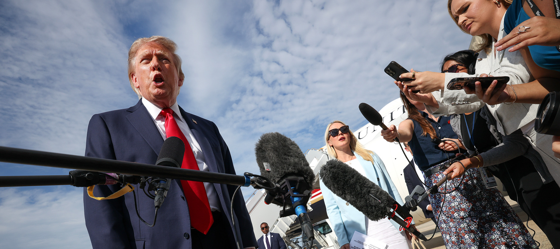 President Trump speaks with reporters before boarding Air Force One.