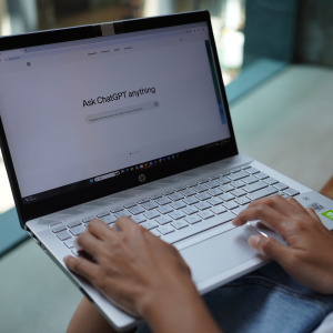 A woman using ChatGPT on her laptop.