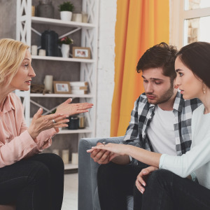 Stressed aunt talking to couple.