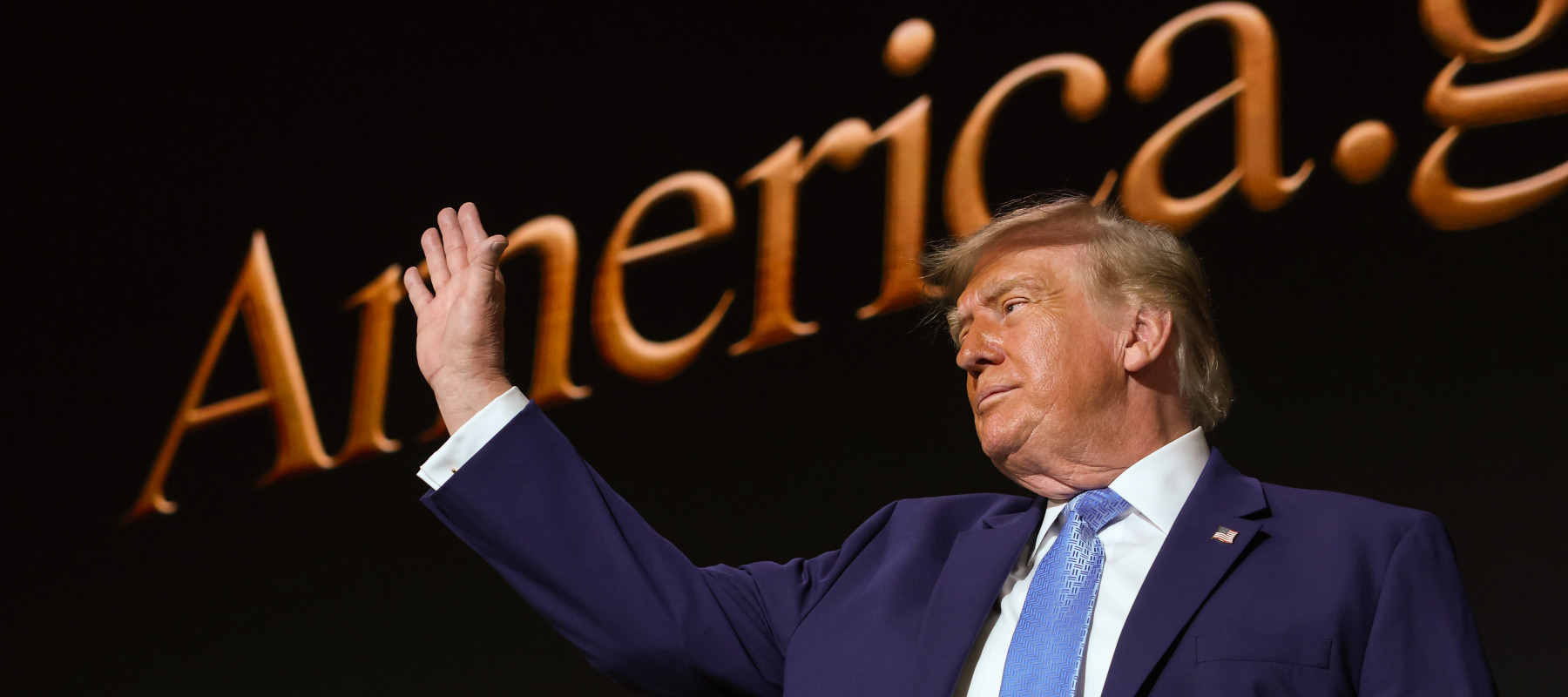Trump waves after speaking during the America.gov launch event.