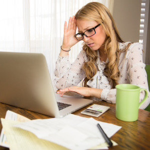 A woman gets frustrated while doing her taxes.