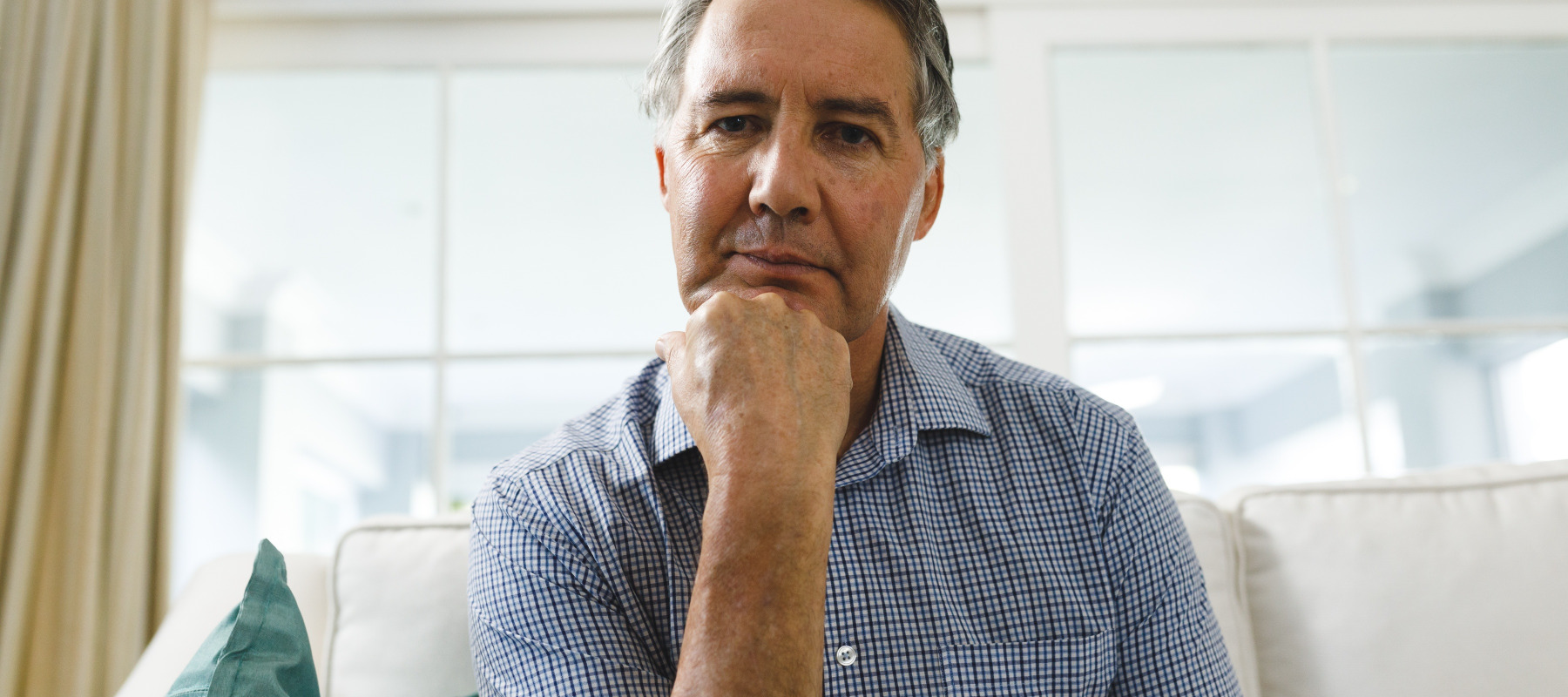 A man thinking in his living room