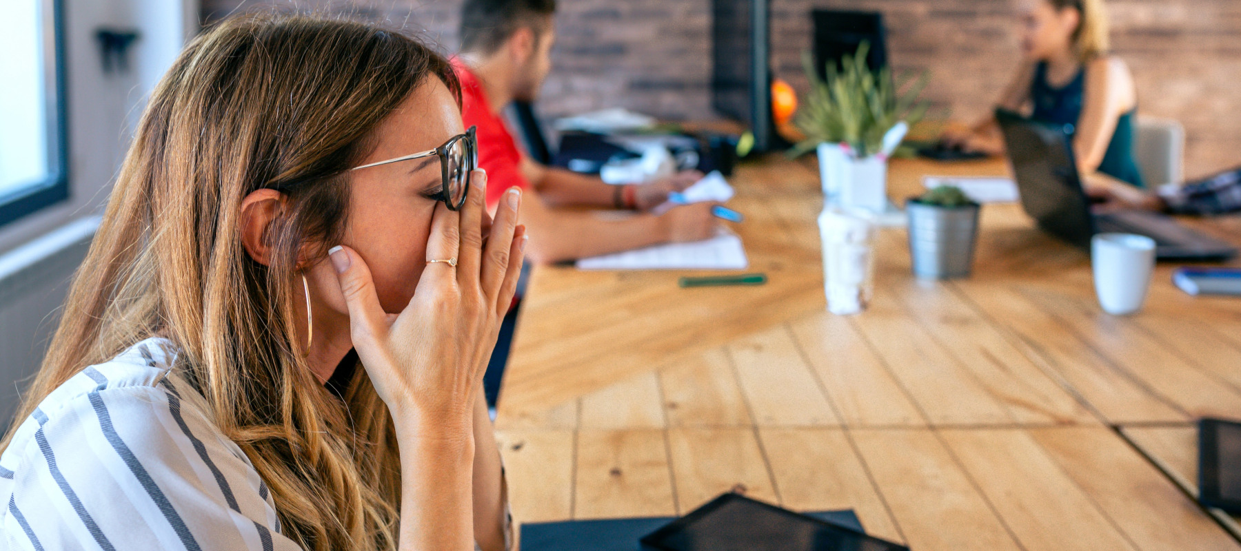 Frustrated woman at co-working desk