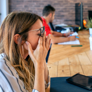 Frustrated woman at co-working desk