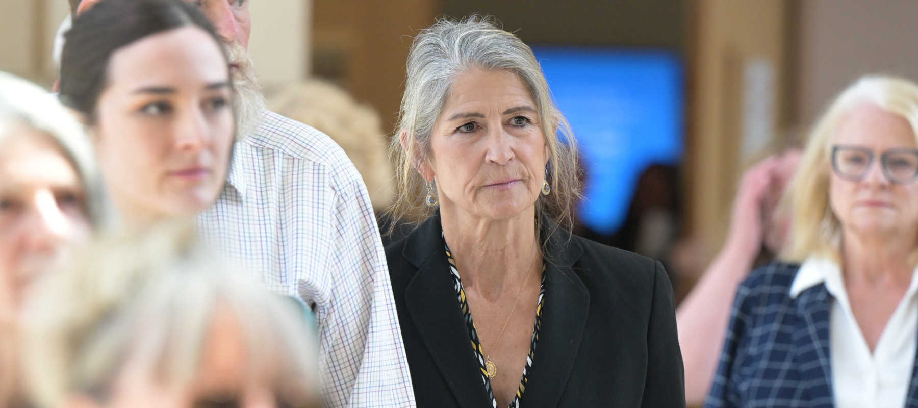 Former Colorado Bureau of Investigation forensic scientist Yvonne "Missy" Woods, center, leaves at Jefferson County District Court in June.
