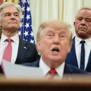 Medicare and Medicaid Administrator Mehmet Oz (L) and US Health and Human Services Secretary Robert F. Kennedy Jr. (R) listen as US President Donald Trump speaks.