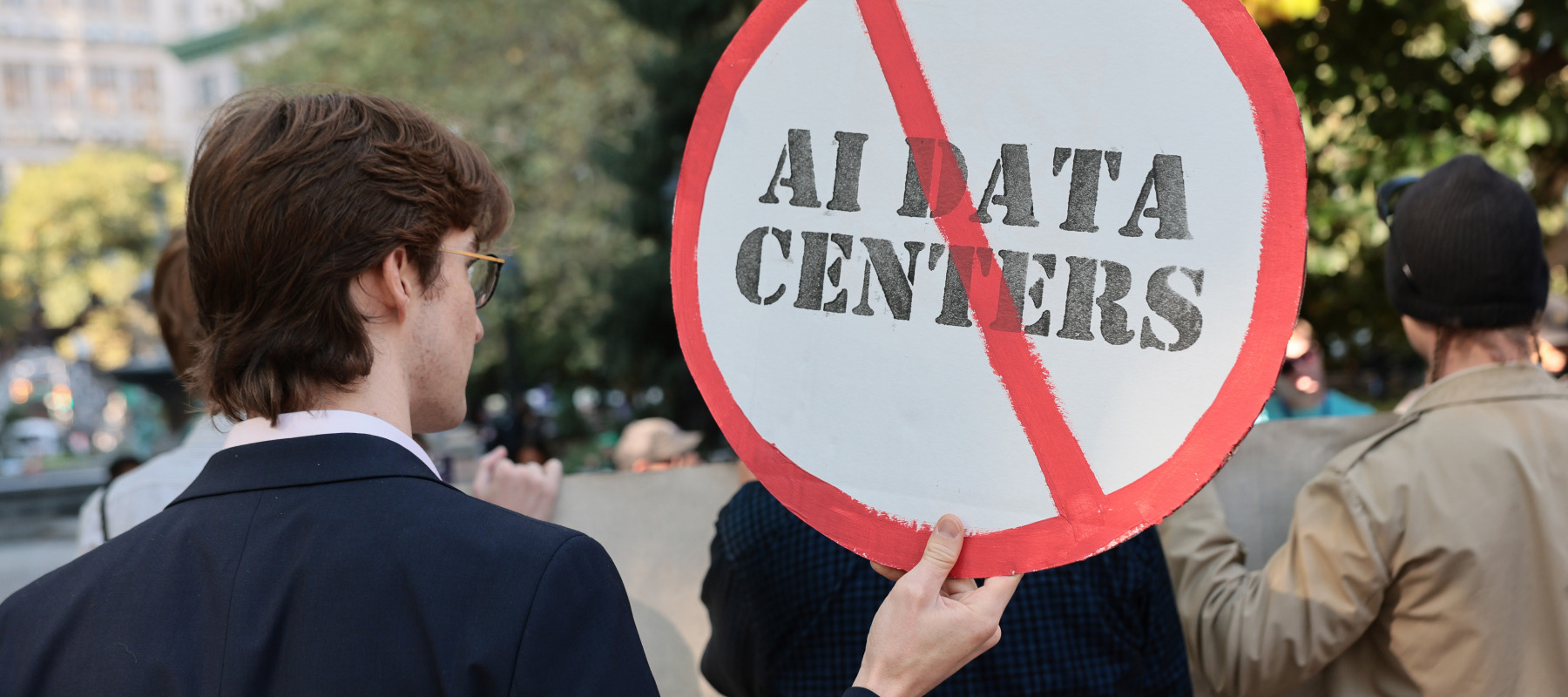 Person holding an anti-AI protest sign