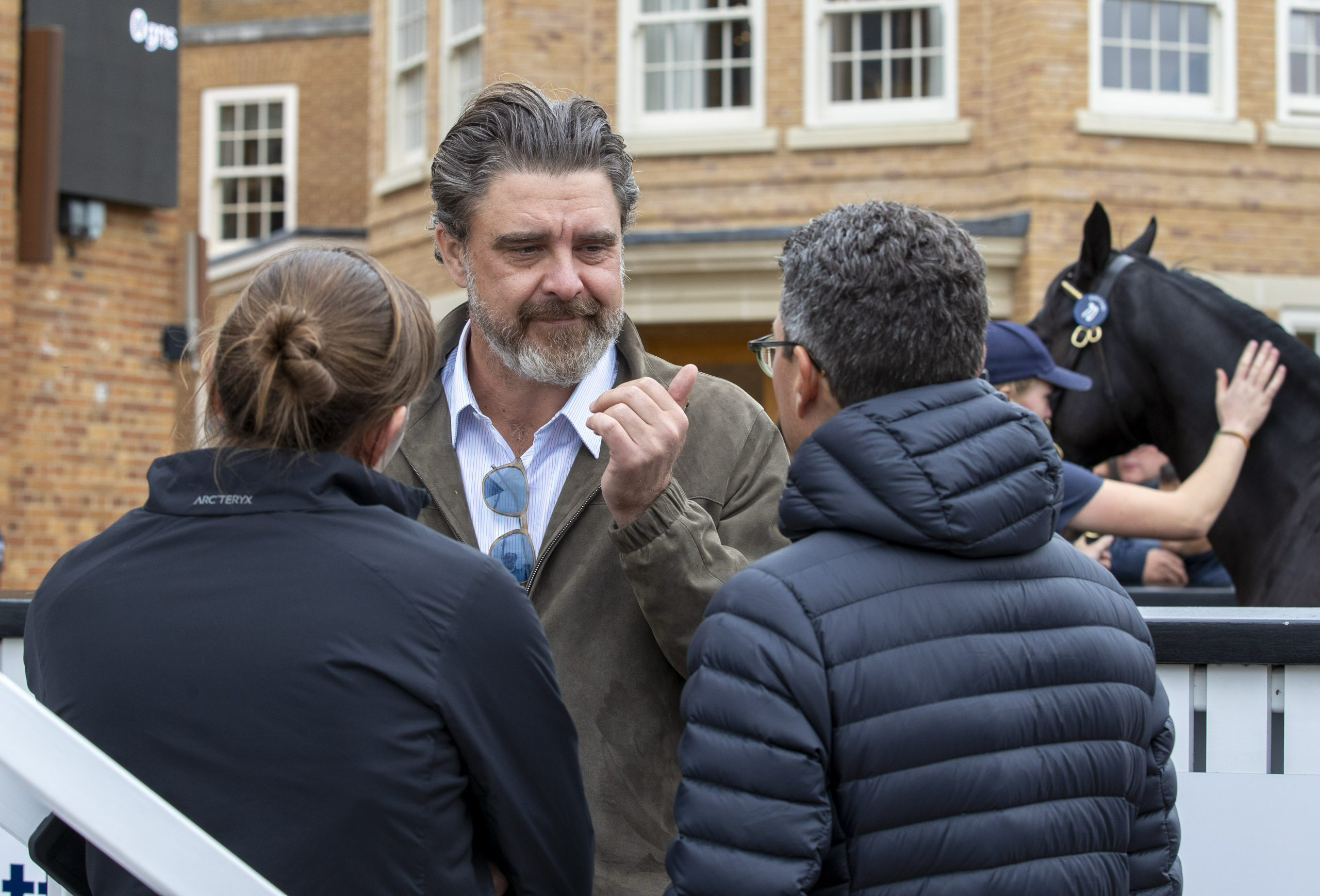 Justin Casse speaks with two people.
