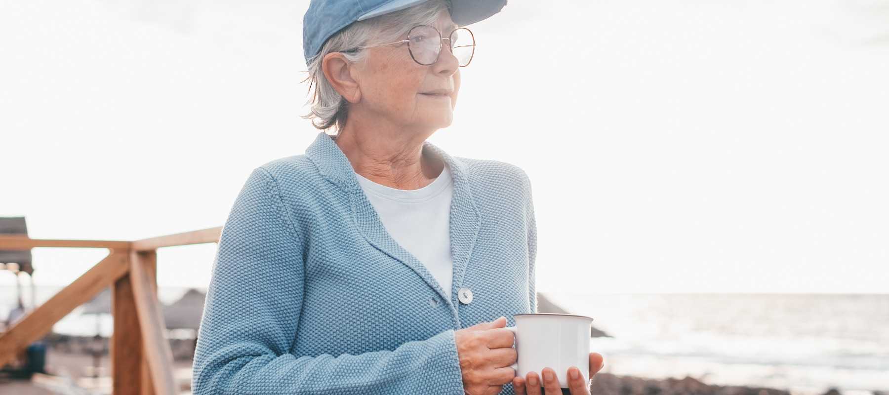 Woman enjoying a coffee at the beach.