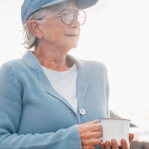 Woman enjoying a coffee at the beach.