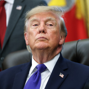 Trump listens to a reporters question in the Oval Office.
