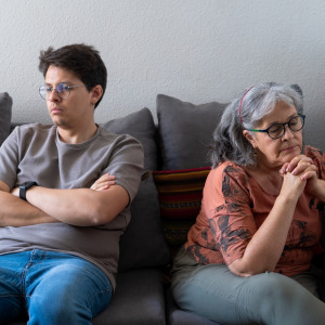 Mother and son upset on the couch.