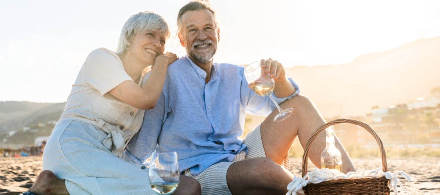 Photo of happy older couple on beach