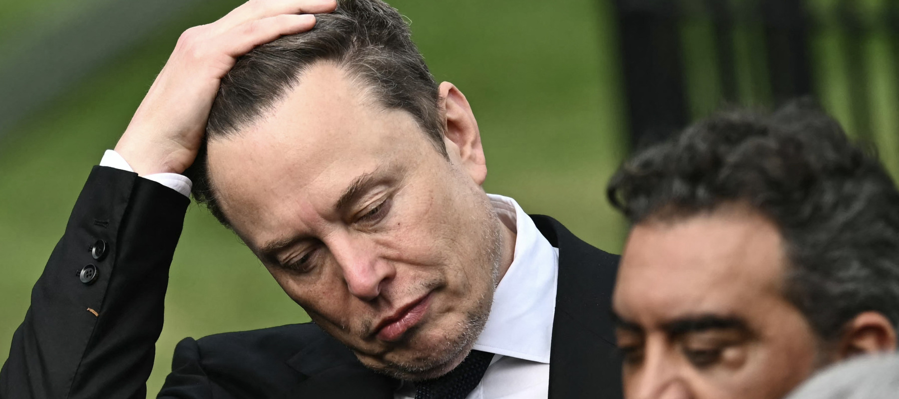 CEO of Tesla and SpaceX Elon Musk reacts as US President Donald Trump speaks to the press after a meeting with technology executives about artificial intelligence at the White House.