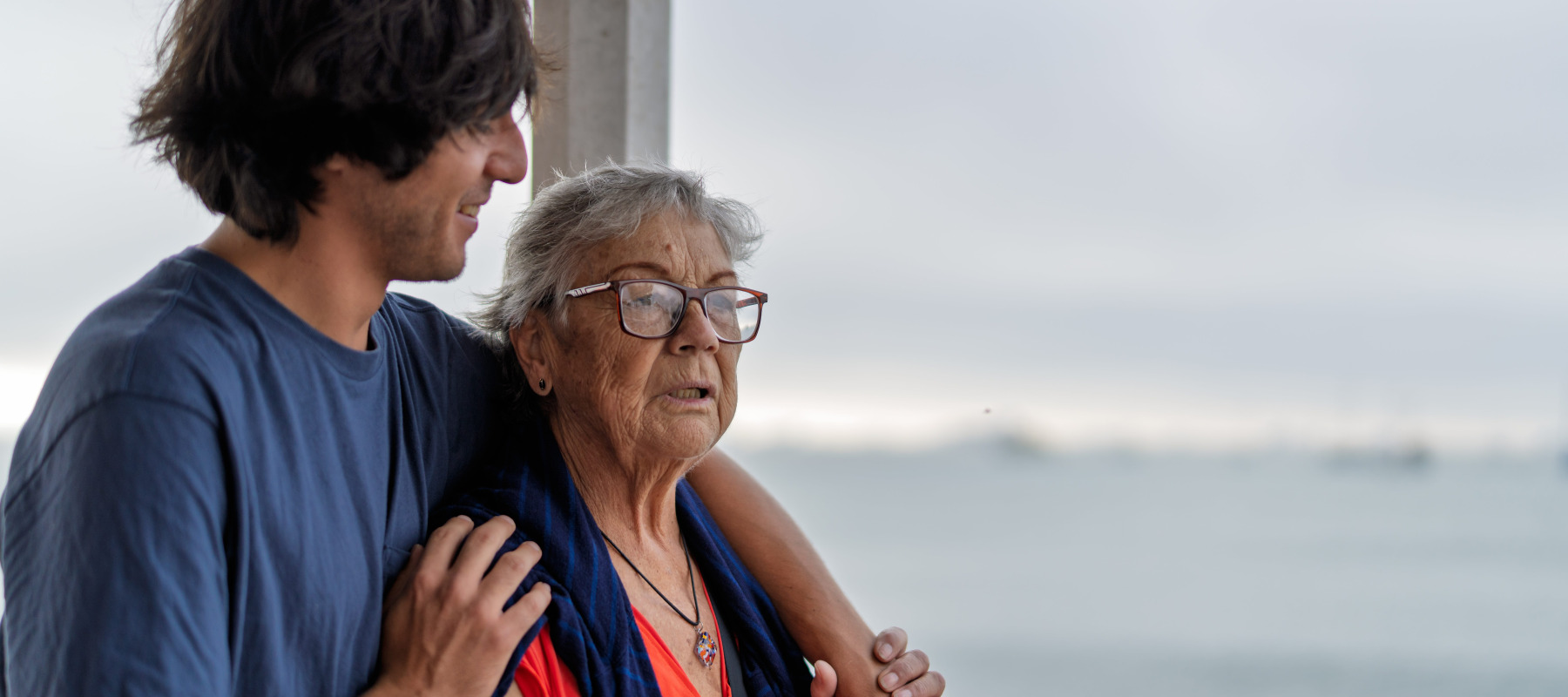 Older woman standing outside with adult son