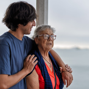 Older woman standing outside with adult son