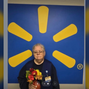 Kentucky Walmart employee posing with flowers
