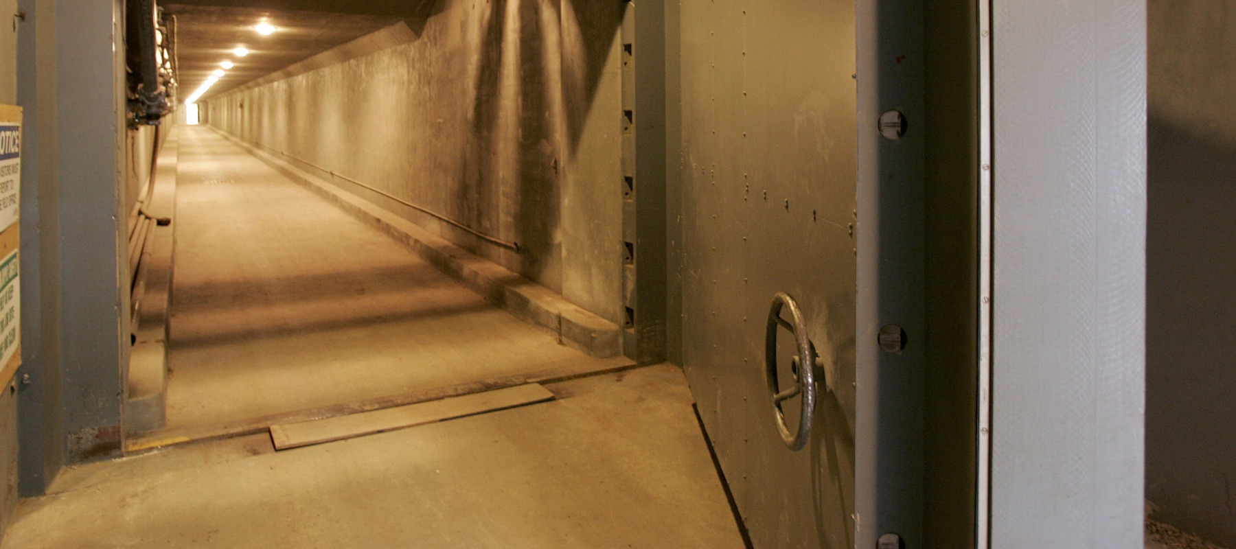 An entrance with a steel door is shown leading to an underground bunker.