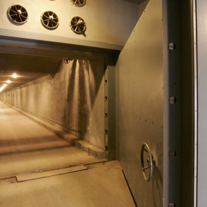 An entrance with a steel door is shown leading to an underground bunker.