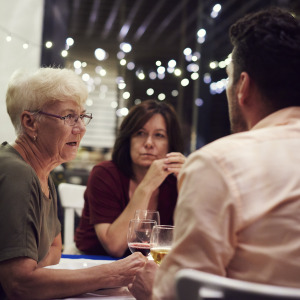 Older woman at dinner with adult children