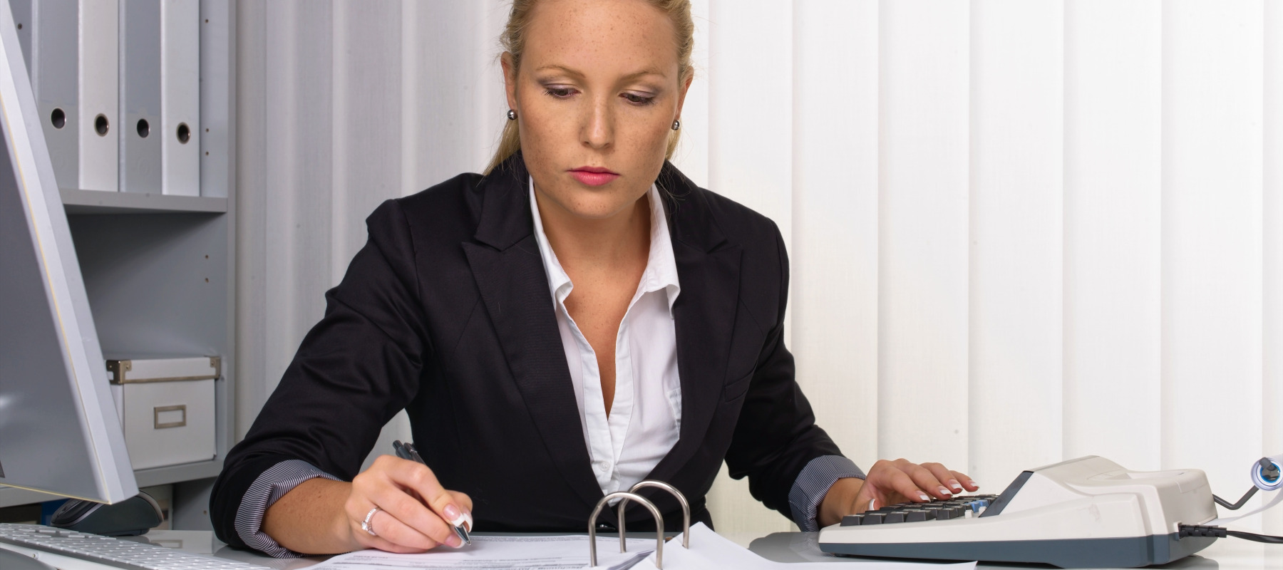 A woman works at her desk.