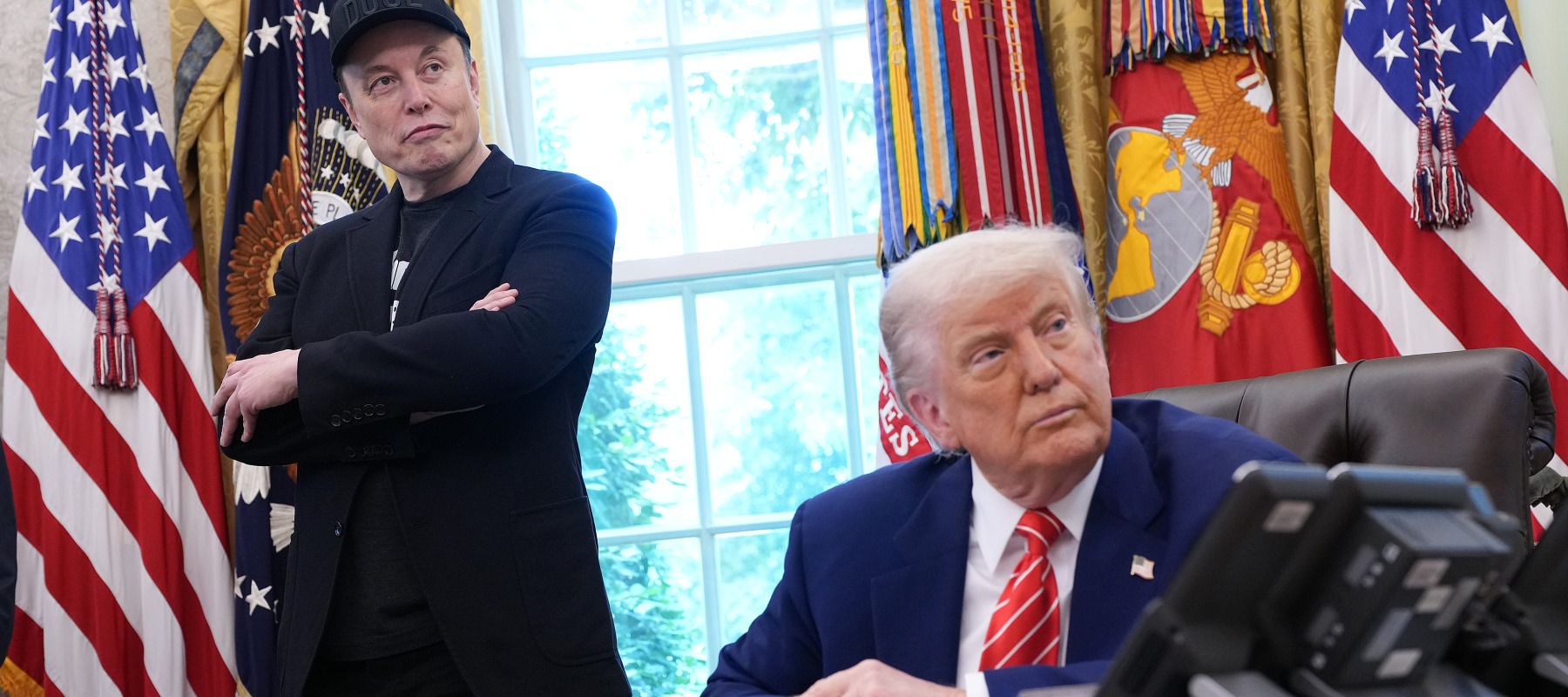 Elon Musk stands next to Trump in the Oval Office.