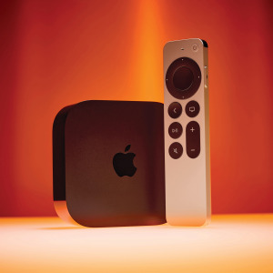 An older generation of the Apple TV 4K box with its remote control.