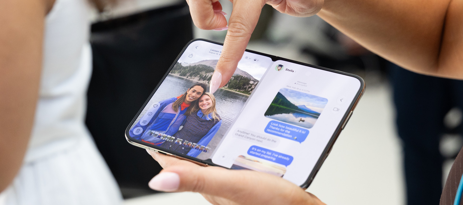 An attendee handles Apple's iPhone Duo, the company's first foldable smartphone, at Apple's "Surprise and Shine" event.