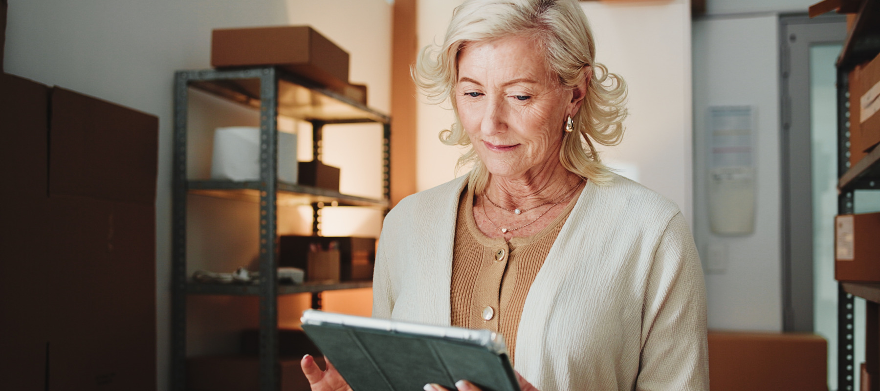 A woman keeps track of her contents on a tablet.