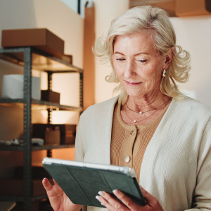 A woman keeps track of her contents on a tablet.