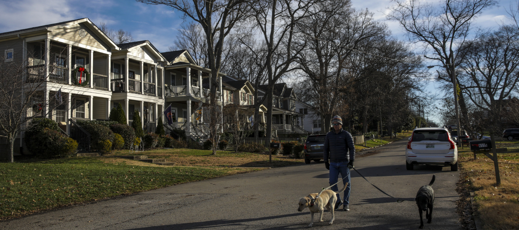 A man walks his dogs in the neighborhood at Utah Avenue and 42nd Ave North in Nashville.
