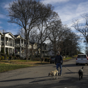 A man walks his dogs in the neighborhood at Utah Avenue and 42nd Ave North in Nashville.