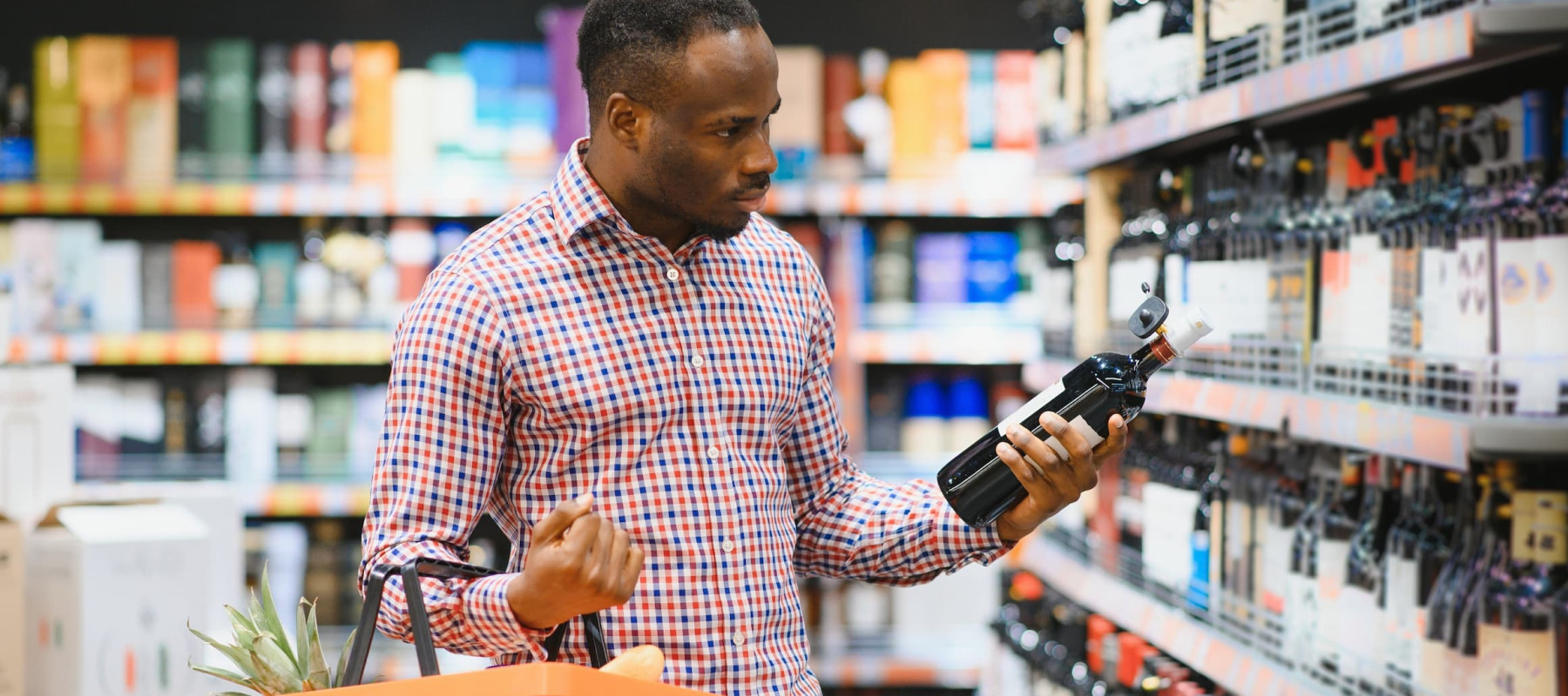 A photo of a man wine shopping