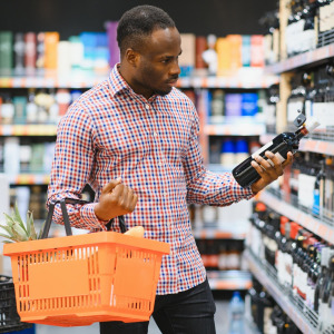 A photo of a man wine shopping