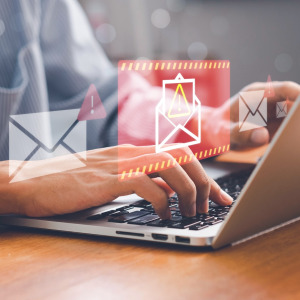 Person using computer receiving scam alert.