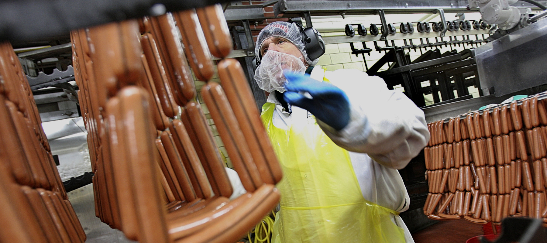 A worker makes hot dogs in a Kayem foods factory.