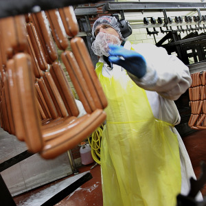 A worker makes hot dogs in a Kayem foods factory.