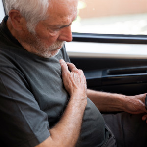 An older adult experiences a heart attack while behind the wheel of his car.