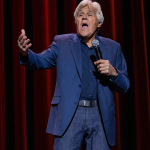 Jay Leno performing on stage.