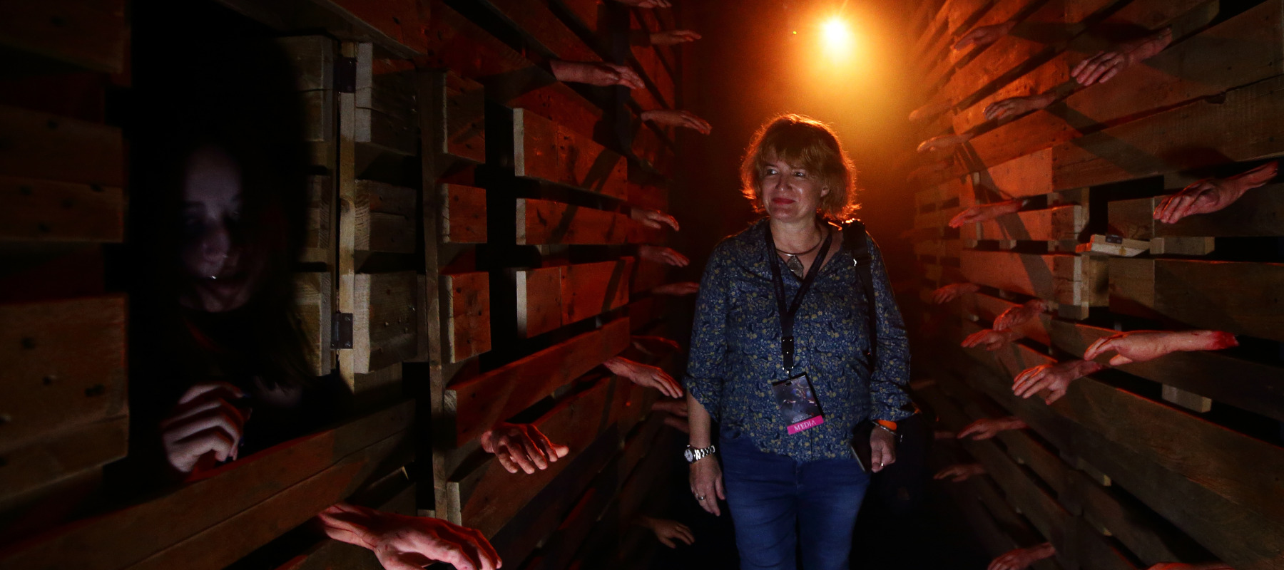 A visitor walks through The Chalet Hauntings haunted house at Universal Studios.