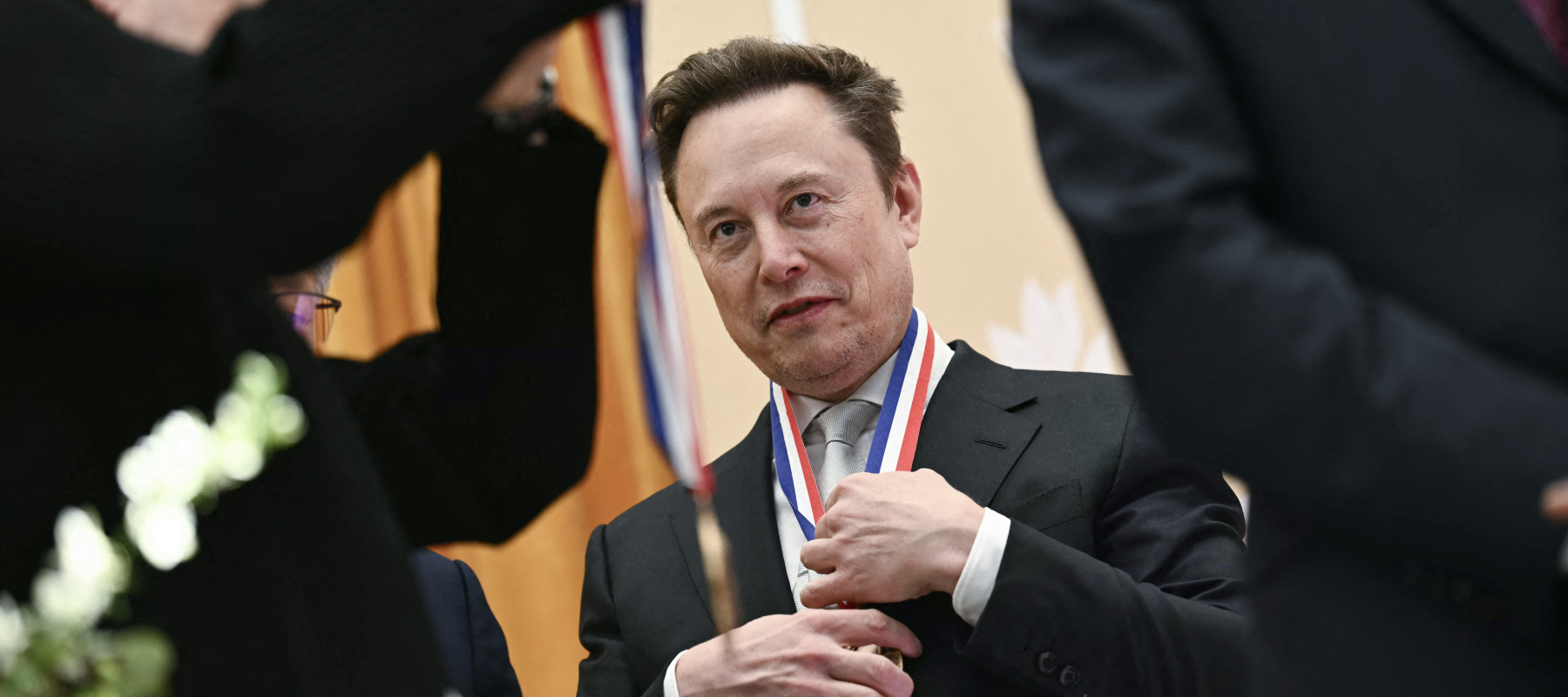 Elon Musk reacts after being awarded the National Medal of Science during the "Golden Age of American Innovation Summit" at the Institute of Peace