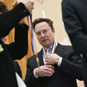 Elon Musk reacts after being awarded the National Medal of Science during the "Golden Age of American Innovation Summit" at the Institute of Peace