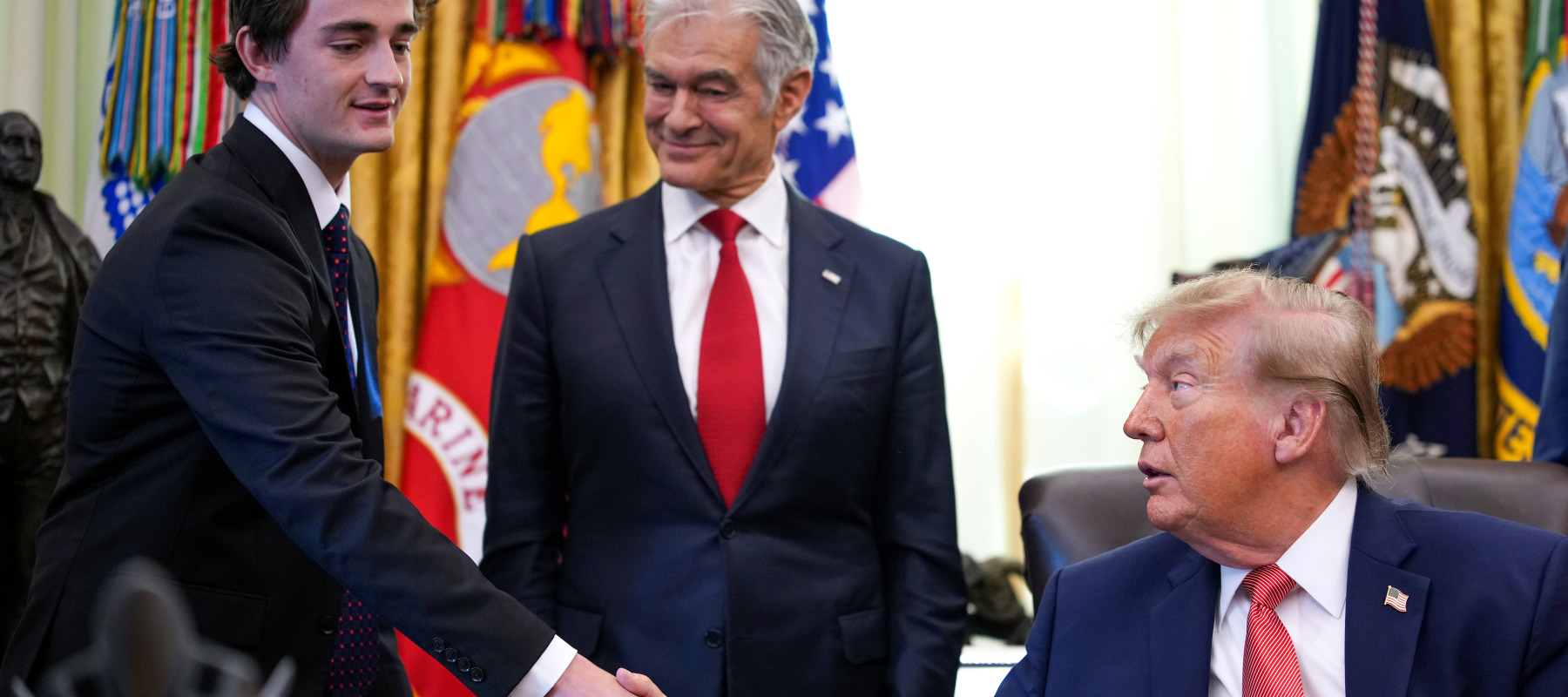 Trump shakes hands with conservative influencer Nick Shirley, who was given $10,000 for uncovering fraud in Minnesota.