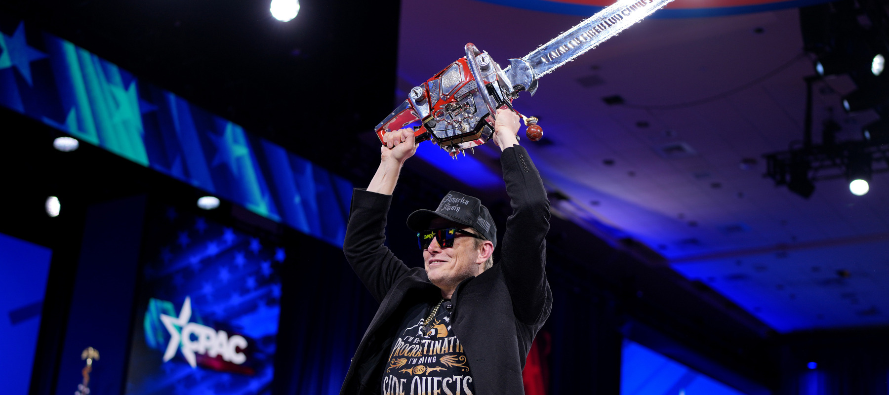 Elon Musk wields a chainsaw as he leaves the stage at the Conservative Political Action Conference.