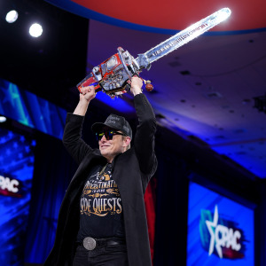 Elon Musk wields a chainsaw as he leaves the stage at the Conservative Political Action Conference.