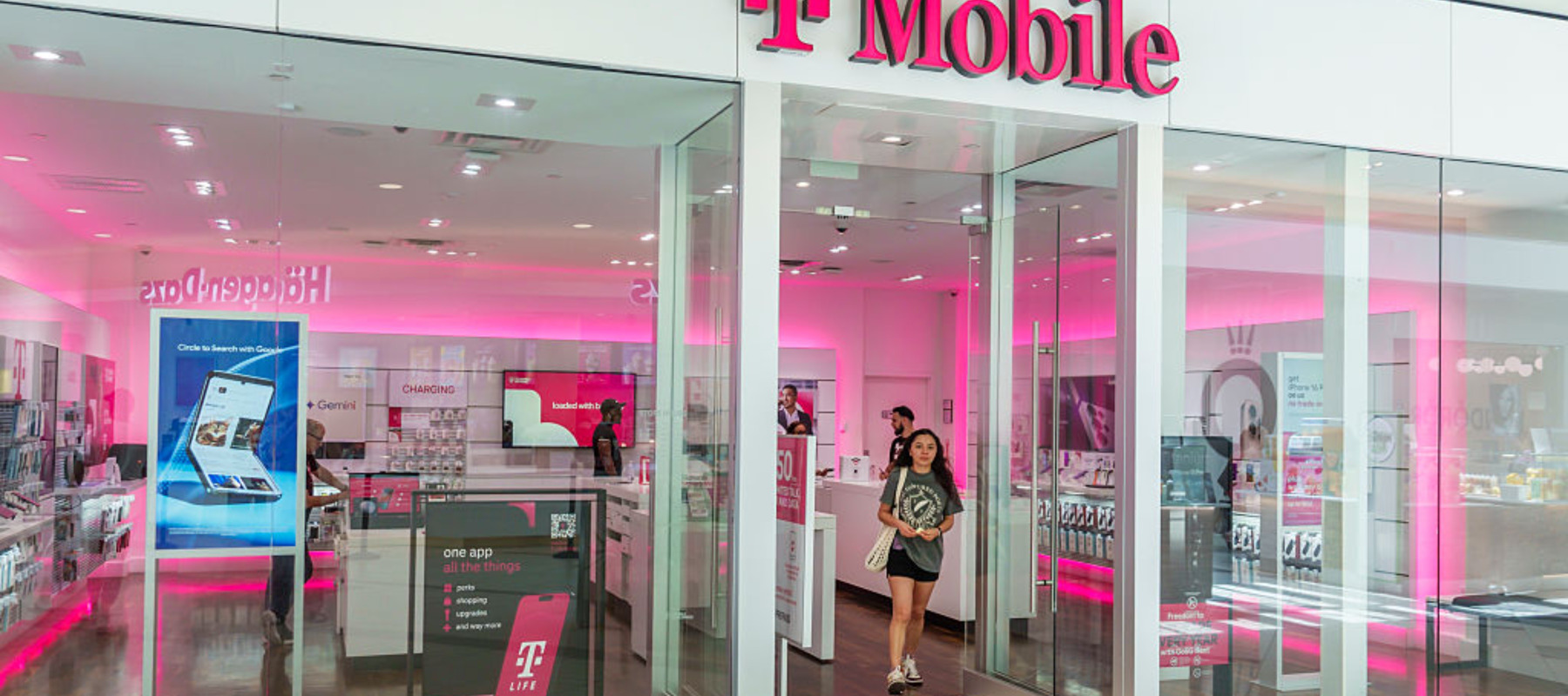 Photo of customer leaving a T-Mobile store