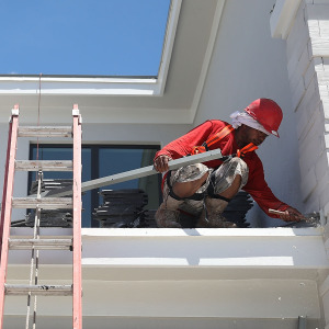 A roofer works on a home in Florida.